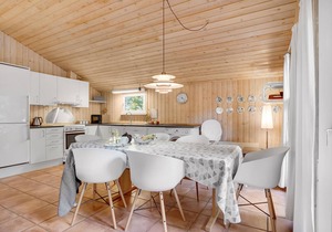 On a hilly natural plot surrounded by trees, lies this beautiful wooden vacation home. in Thisted